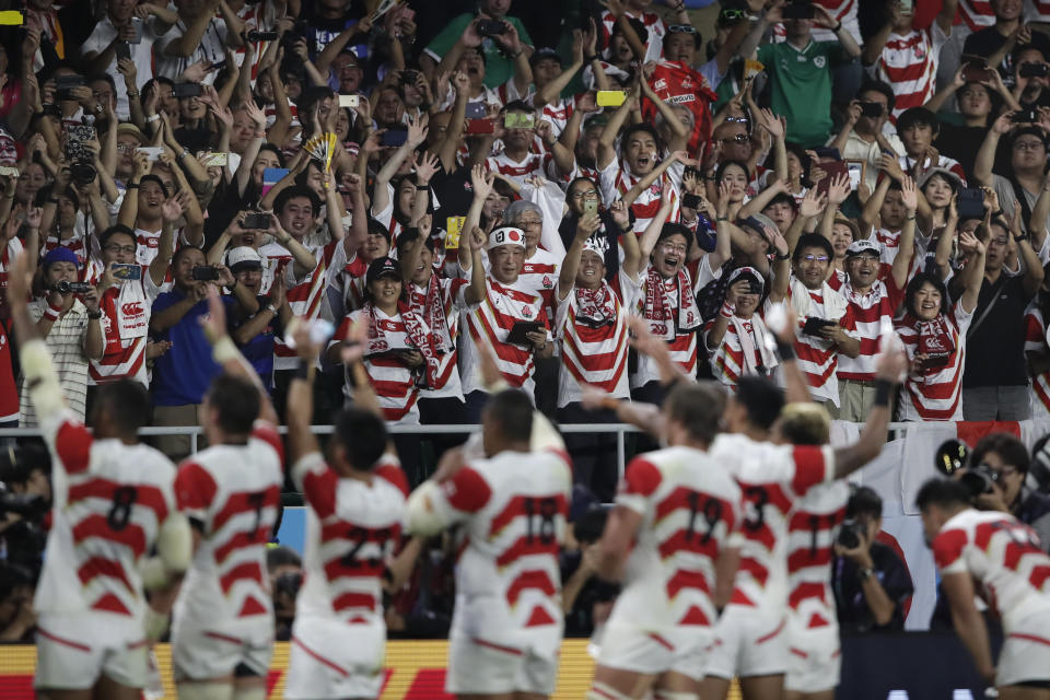 Japan team wave to their supporters after defeating Ireland 19-12 in their Rugby World Cup Pool A game at Shizuoka Stadium Ecopa in Shizuoka, Japan, Saturday, Sept. 28, 2019. (AP Photo/Jae C. Hong)