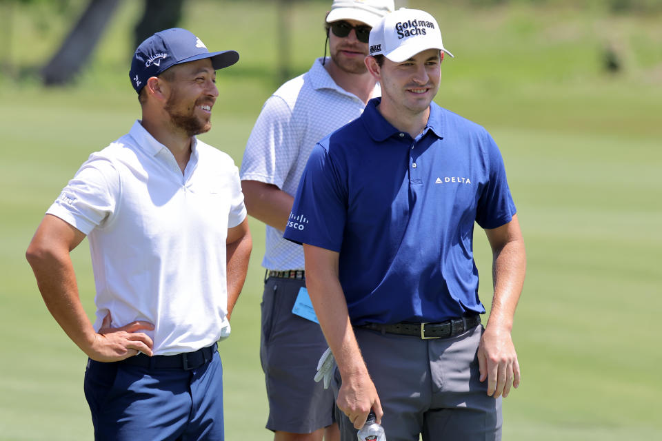 Xander Schauffele and Patrick Cantlay react during the pro-am prior to the Zurich Classic