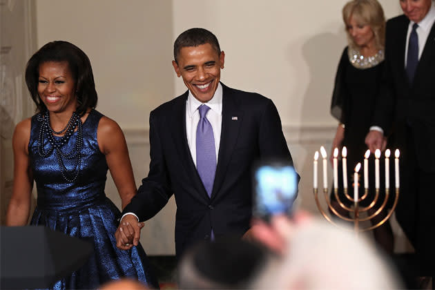 <b>December 2011</b> <br>At the White House Hanukah reception, Michelle wears a metallic blue dress by Rodarte.