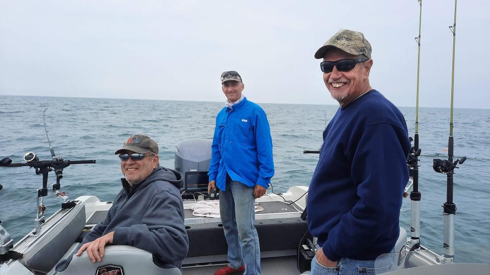 Hiring a charter fishing guide to fish for walleye is a fun way to spend a day on Lake Erie. From left, Keith Brant, Capt. Keith Eshbaugh and Randy Miller try their luck during a June 8 excursion. Remember to dress in layers as the air on the lake is usually about 10 degrees colder.