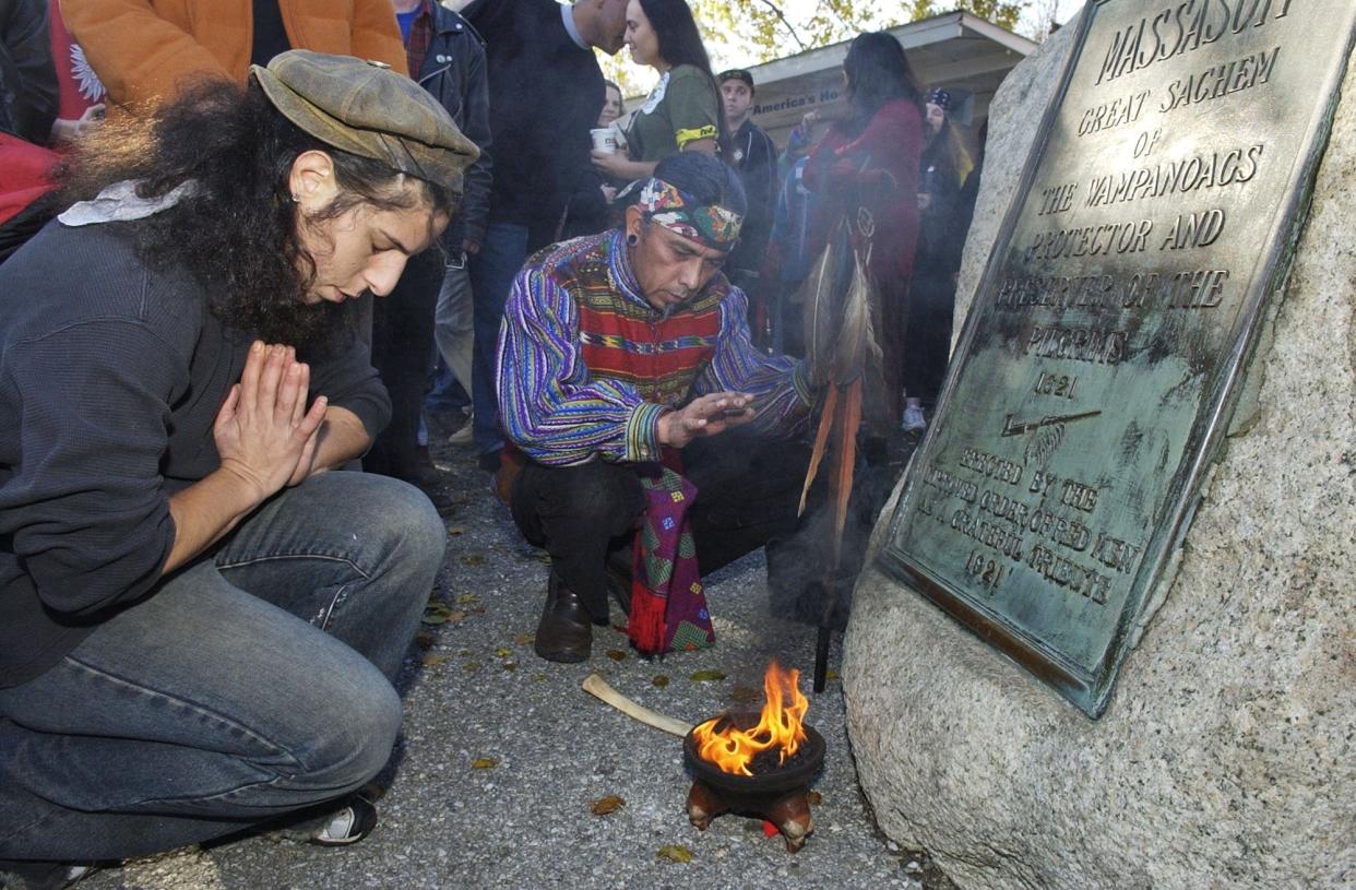 FILE- Supporters of Native Americans pause following a prayer during the 38th National Day of Mourning at Coles Hill in Plymouth, Mass., on Nov. 22, 2007. Denouncing centuries of racism and mistreatment of Indigenous people, members of Native American tribes from around New England will gather on Thanksgiving 2021 for a solemn National Day of Mourning observance. (AP Photo/Lisa Poole, File)