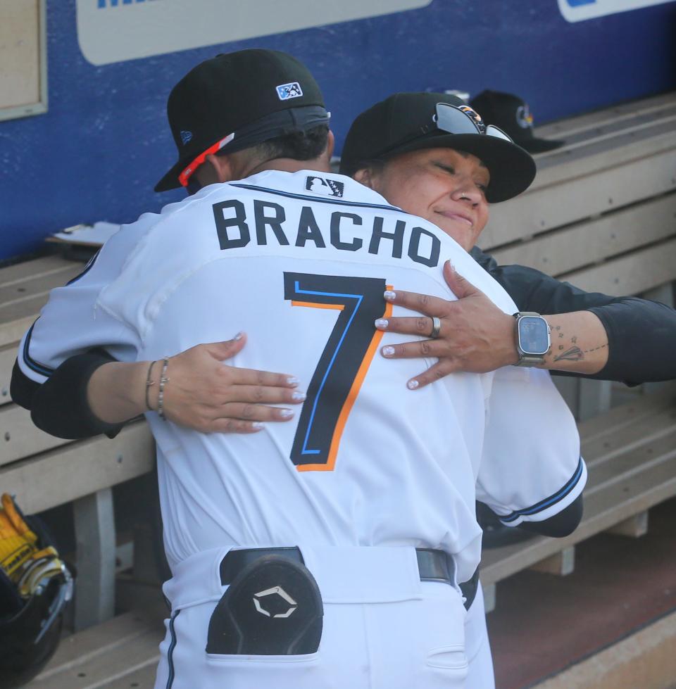 RubberDucks assistant hitting coach Amanda Kamekona gets a hug from Aaron Bracho before the game against the Erie SeaWolves earlier this week.