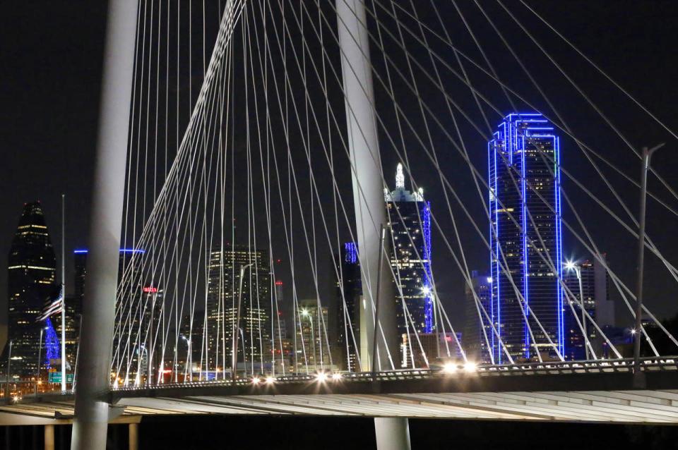 The Dallas city skyline is seen through the Margaret Hunt Hill Bridge