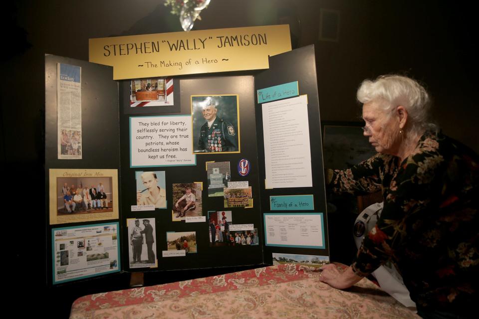 World War II veteran Stephen "Wally" Jamison's wife Margaret looks over a montage made to honor him at their Jackson home Wednesday, February 15, 2023.  His hometown is throwing a parade to honor Jamison with parade as he turns 100 on Saturday.