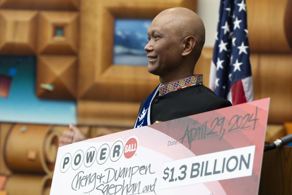 Cheng "Charlie" Saephan holds display check before speaking during a news conference where it was revealed that he was one of the winners of the $1.3 billion Powerball jackpot at the Oregon Lottery headquarters on Monday, April 29, 2024, in Salem, Ore. (AP Photo/Jenny Kane)
