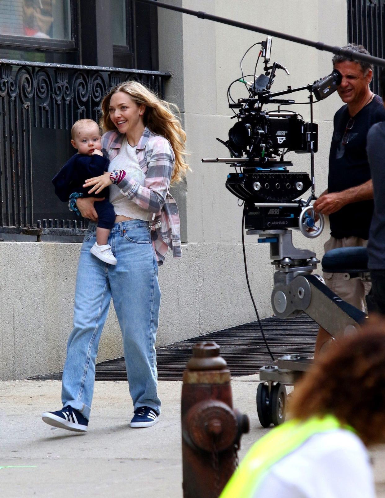 Amanda Seyfried is seen filming an intense running scene through the streets of Downtown Brooklyn while holding a fake baby doll for the upcoming film "A Mouthful of Air." Later in the day, the fake baby was replaced by a real one as she shot more scenes with costar Finn Wittrock.