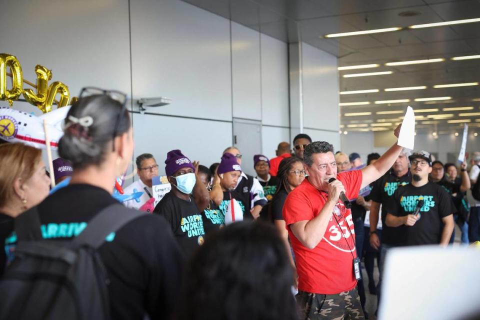 Hector Canales, right, a Chili’s worker at Miami airport, speaks during a Thursday protest of airport union workers demanding better wages, paid sick leave and other benefits.