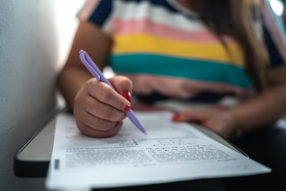 Person filling out a form on a plane, likely preparing for travel procedures