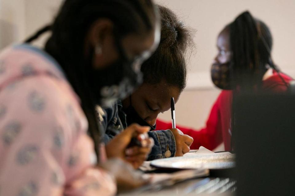 From left: Asia Dorsett, 12, Shamiyah Brown, 12, and Summer Miller, 12, all seventh-graders at Charles R. Drew K-8 Center, study after school at Miller’s home in Liberty City on Tuesday, Feb. 9, 2021.