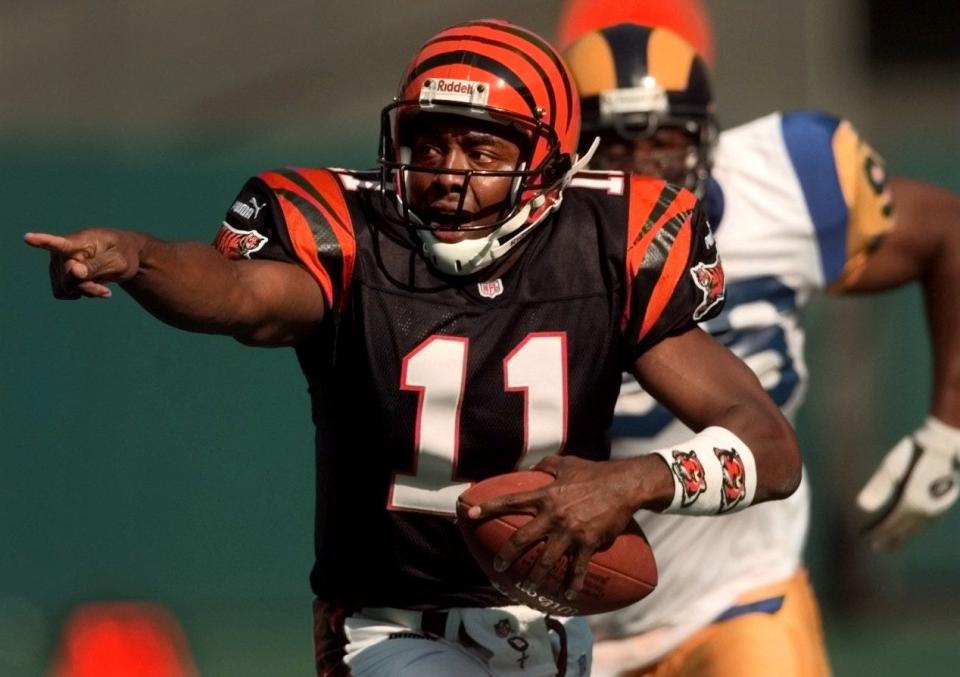 OCTOBER 3, 1999: Bengals quarterback Akili Smith yells for receivers while being pressured by the Rams Jay Williams during the fourth quarter at Cinergy Field.