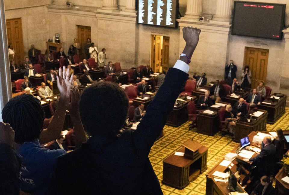 Expelled State Rep. Justin Pearson, D-Memphis, raises his fist as he listens to State Rep. Justin Jones, D-Nashville, deliver remarks in the House chamber Monday, April 10, 2023, in Nashville, Tenn. Jones, who was expelled last week from the GOP-led Tennessee House over his role in a gun-control protest on the House floor, was reinstated Monday after Nashville’s governing council voted to send him straight back to the Legislature. (AP Photo/George Walker IV)