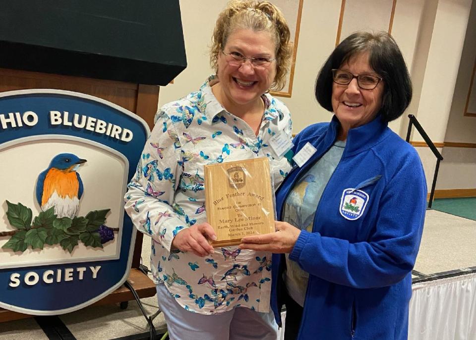 The Ohio Bluebird Society's conference in Ashland on March 2 brought a surprise for Mary Lee Minor. The OBS treasurer Molly Wilsbacher (left) presented the "Blue Feather Award" to Mary Lee for many years of energetic and creative support for the society.