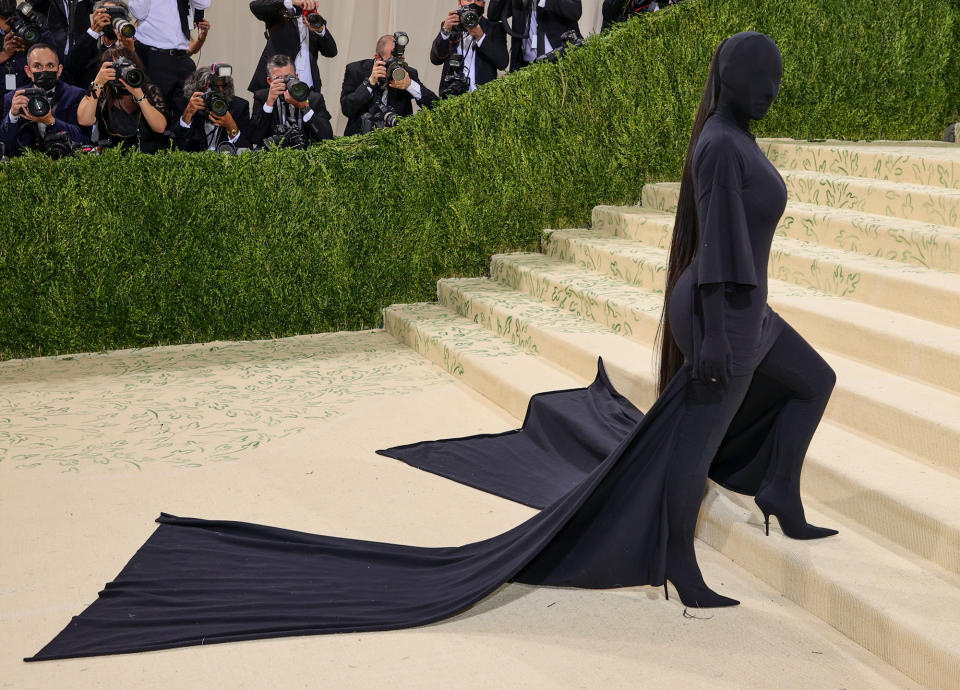 <p>As her previous outfit teased, Kim's Met Gala look became the subject of conversation when <a href="https://people.com/style/met-gala-2021-kim-kardashian-wears-full-covered-look-head-mask/" rel="nofollow noopener" target="_blank" data-ylk="slk:she showed up in a covered-up custom Balenciaga ensemble;elm:context_link;itc:0;sec:content-canvas" class="link ">she showed up in a covered-up custom Balenciaga ensemble</a>, featuring a long-sleeve turtleneck bodysuit worn under an oversize T-shirt dress with long pleated train. She also wore jersey boots, jersey gloves and a mask that covered her face and head.</p> <p>The look has already been made into a <a href="https://people.com/style/met-gala-2021-kim-kardashian-balenciaga-look-turned-into-halloween-costume/" rel="nofollow noopener" target="_blank" data-ylk="slk:Halloween costume;elm:context_link;itc:0;sec:content-canvas" class="link ">Halloween costume</a> and inspired countless memes and a <a href="https://people.com/style/met-gala-2021-kim-kardashian-couldnt-see-kendall-jenner-through-her-balenciaga-mask/" rel="nofollow noopener" target="_blank" data-ylk="slk:viral photo of the moment;elm:context_link;itc:0;sec:content-canvas" class="link ">viral photo of the moment</a> when sister Kendall first spotted Kim on the red carpet with a baffled look on her face.</p>