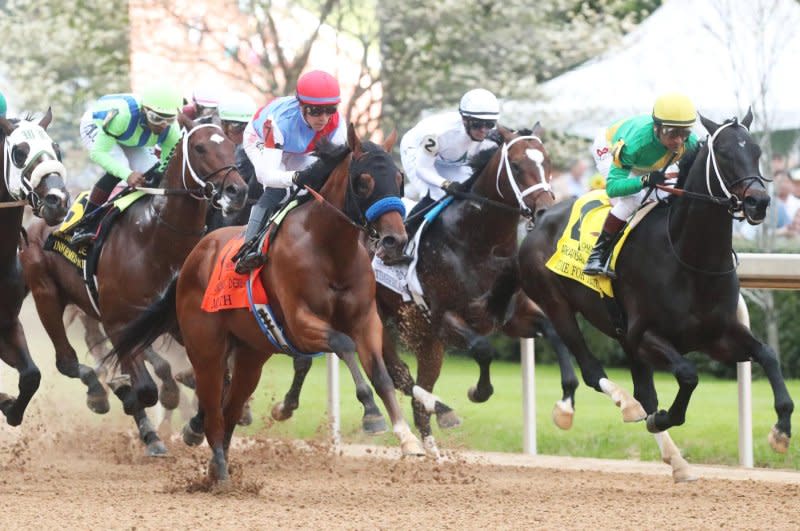 Muth (jockey in red cap), shown winning the Arkansas Derby, is expected to head up trainer Bob Baffert's two runners in the May 18 Preakness Stakes, second leg of the U.S. Triple Crown. Coady Photography, courtesy of Oaklawn Park