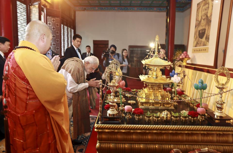 Indian Prime Minister Narendra Modi bows as he visits the Daxingshan Buddhist temple, in Xian