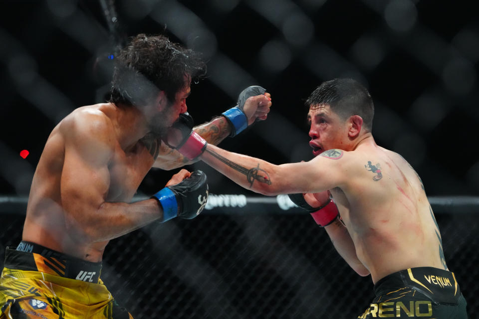 Jul 8, 2023; Las Vegas, Nevada, USA; Brandon Moreno (red gloves) fights Alexandre Pantoja (blue gloves) during UFC 290 at T-Mobile Arena. Mandatory Credit: Stephen R. Sylvanie-USA TODAY Sports