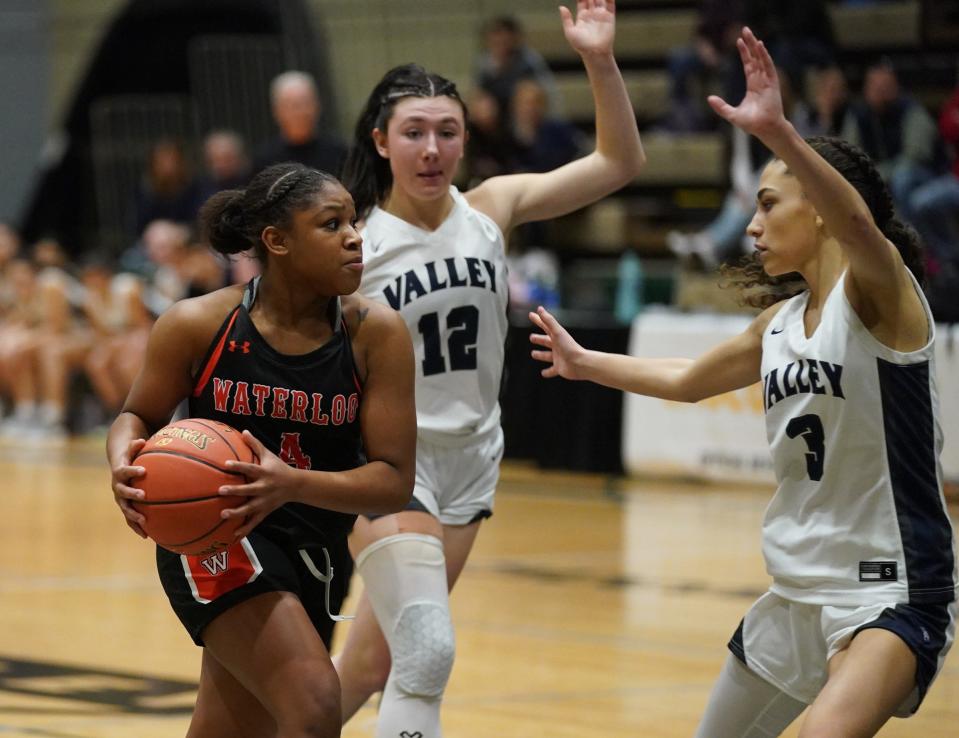 Waterloo's Jazzmyn Lewis (4) drives past Putnam Valley's Ava Harmon (12) and Naieliz Torres (3)  in the girls NYSPHSAA Class B championship game at Hudson Valley Community College in Troy, on Saturday, March 18, 2023.