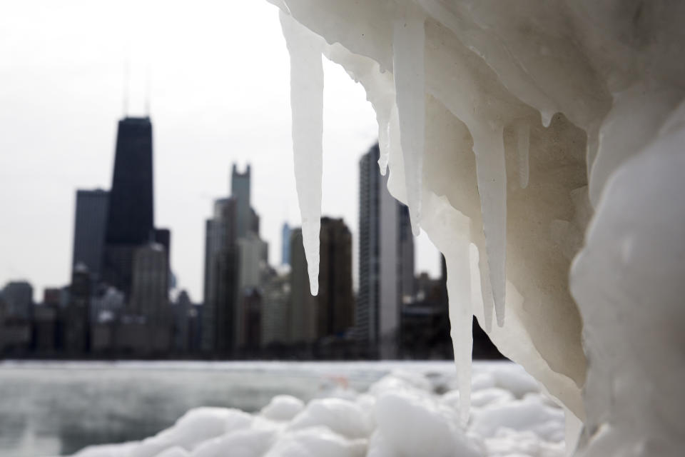 The Chicago skyline is photographed behind a large chunk of ice near North Avenue Beach as cold temperatures remain with wind chills nearing minus 30 Fahrenheit on Tuesday, Jan. 7, 2014, in Chicago. Dangerously cold polar air snapped decades-old records as it spread Tuesday from the Midwest to southern and eastern parts of the U.S. and eastern Canada, making it hazardous to venture outside and keeping many schools and businesses closed. (AP Photo/Andrew A. Nelles)