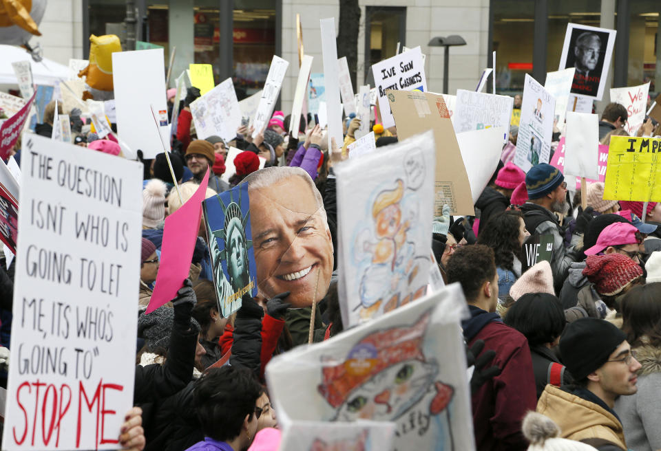 WASHINGTON, DC - JANUARY 19: Demonstrators display their signs, including a cut-out of former VP Joe Biden (C) who may make a bid for the presidency in 2020, during the 2019 Women's March on January 19, 2019 in Washington, DC.  Thousands of women gathered in the US capital and across the country to support women's rights and to oppose President Donald Trump's policies. (Photo by Paul Morigi/Getty Images)