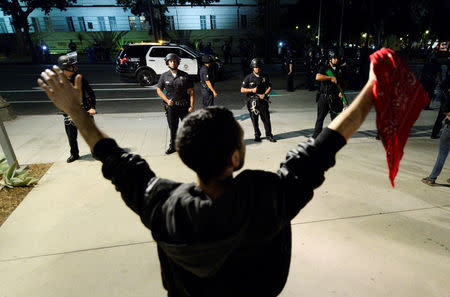 A protestor holds up his hands as Los Angeles Police officer look on, after a dispersal order was ignored by the protestors, during a protest and march against the election of Republican Donald Trump as President of the United States in Los Angeles, California, U.S. November 12, 2016. REUTERS/Kevork Djansezian