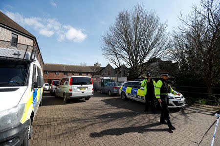 Police officers stand by police tape as inspectors from the Organisation for the Prohibition of Chemical Weapons (OPCW) arrive to begin work at the scene of the nerve agent attack on former Russian agent Sergei Skripal, in Salisbury, Britain March 21, 2018. REUTERS/Peter Nicholls