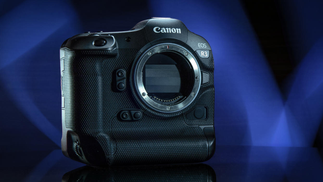  Canon EOS R3 against a deep blue background with stylized lighting. 