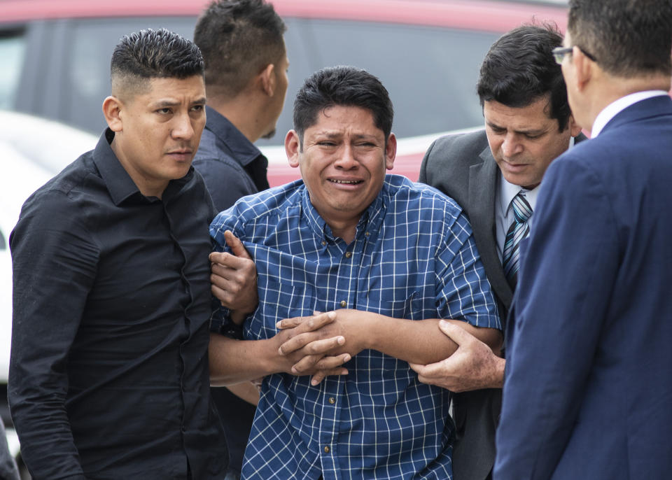 Arnulfo Ochoa, the father of Marlen Ochoa-Lopez, is surrounded by family members and supporters, as he walks into the Cook County medical examiner's office to identify his daughter's body, Thursday, May 16, 2019 in Chicago.