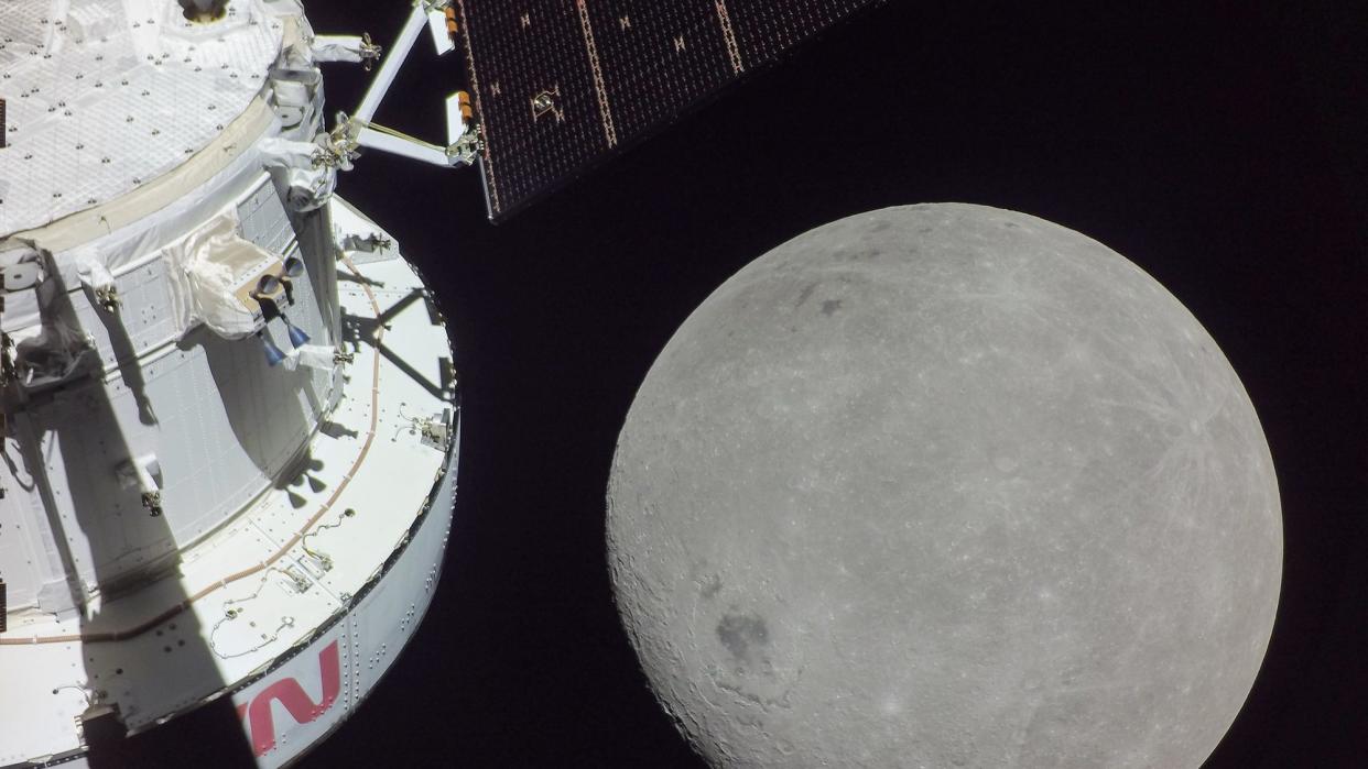 A portion of the far side of the Moon looms large just beyond the Orion spacecraft in this image taken November 21, 2022, by a camera on the tip of one of Orion’s solar arrays. The darkest spot visible near the middle of the image is Mare Orientale.