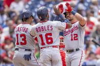 Washington Nationals' Kyle Schwarber (12) is congratulated by Starlin Castro (13) and Victor Robles (16) after hitting a three-run homer during the fifth inning of a baseball game against the Philadelphia Phillies, Wednesday, June 23, 2021, in Philadelphia. (AP Photo/Laurence Kesterson)