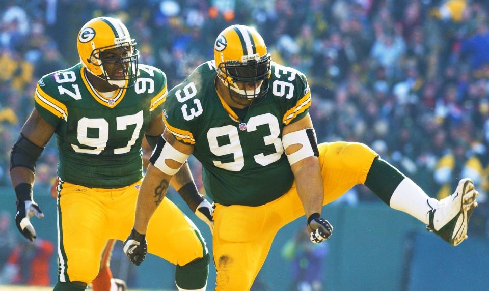 Green Bay Packers' Gilbert Brown (93) and Cletidus Hunt (97) react after Brown sacked San Francisco 49ers' quarterback Jeff Garcia in the first quarter of their NFC wild card playoff game Sunday, Jan. 13, 2002, in Green Bay, Wis.
