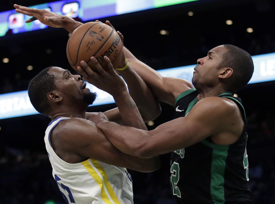 Golden State Warriors forward Kevin Durant, left, is fouled by Boston Celtics center Al Horford as he goes up to shoot in the second half of an NBA basketball game, Saturday, Jan. 26, 2019, in Boston. (AP Photo/Elise Amendola)