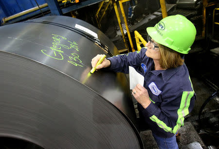 A finished steel coil is marked with its information by a worker at the Novolipetsk Steel PAO steel mill in Farrell, Pennsylvania, U.S., March 9, 2018. REUTERS/Aaron Josefczyk