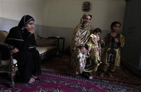 Saeeda Sarbazi (L) sits near her sister-in-law Gul Afroz, wife of Abdul Razzaq Baloch, during an interview with Reuters at their residence in Karachi June 3, 2013. REUTERS/Stringer