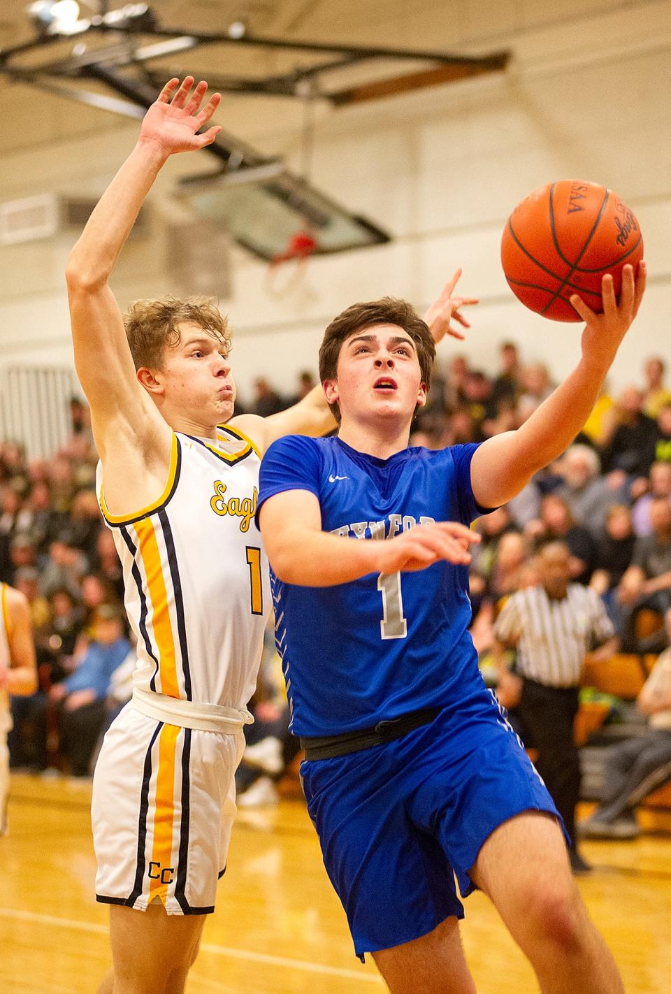 Wynford's Drew Johnson lays the ball up ahead of Colonel Crawford's Trevor Vogt.