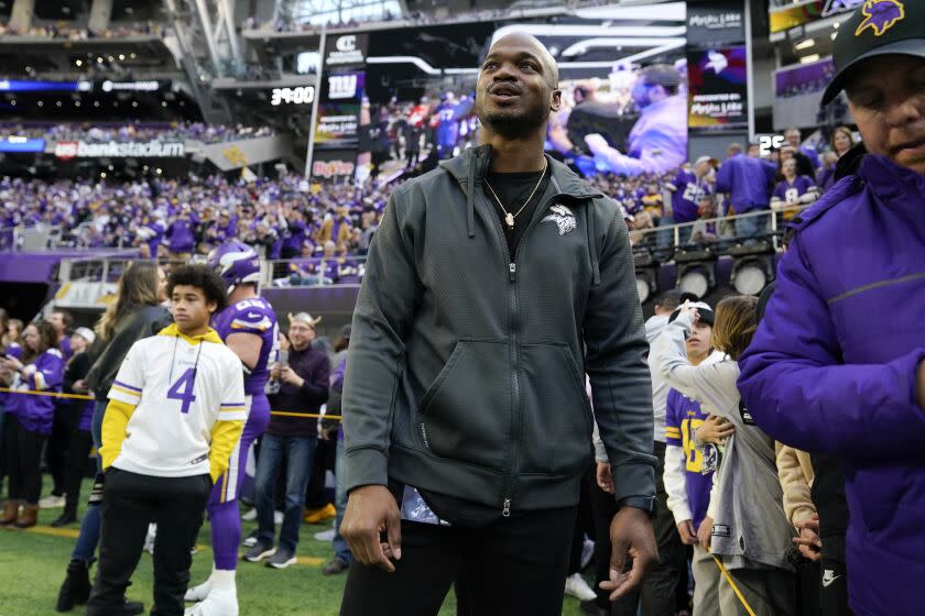 Former Minnesota Vikings running back Adrian Peterson stands on the field before an NFL wild card playoff football game