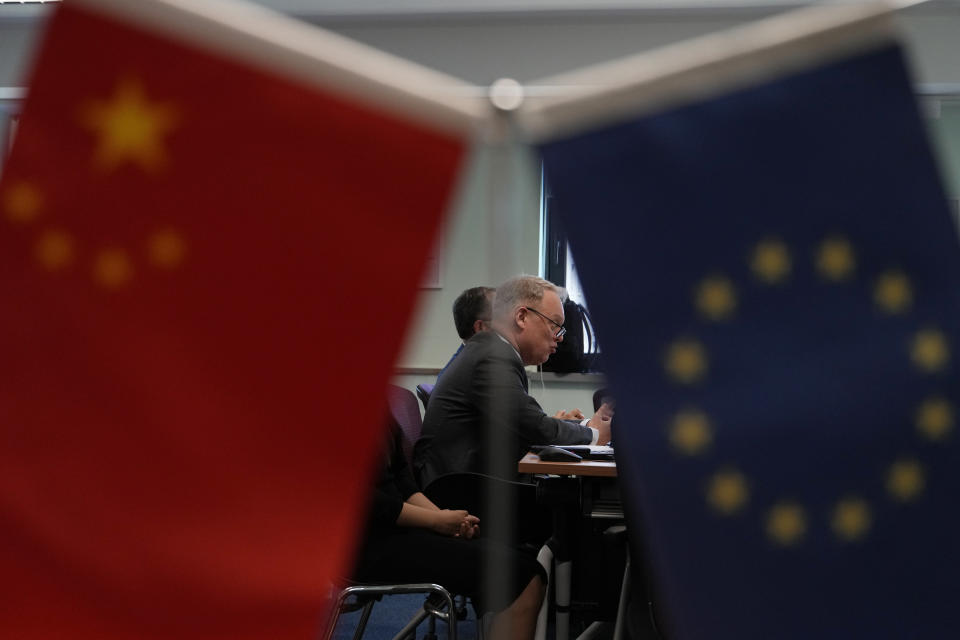 Jens Eskelund, president of the European Chamber is framed by the Chinese and European Union flag during the launch of the European Business in China: Business Confidence Survey in Beijing, Wednesday, June 21, 2023. Foreign companies are shifting investments and their Asian headquarters out of China as confidence plunges following the expansion of an anti-spying law and other challenges, the business group said Wednesday. (AP Photo/Ng Han Guan)