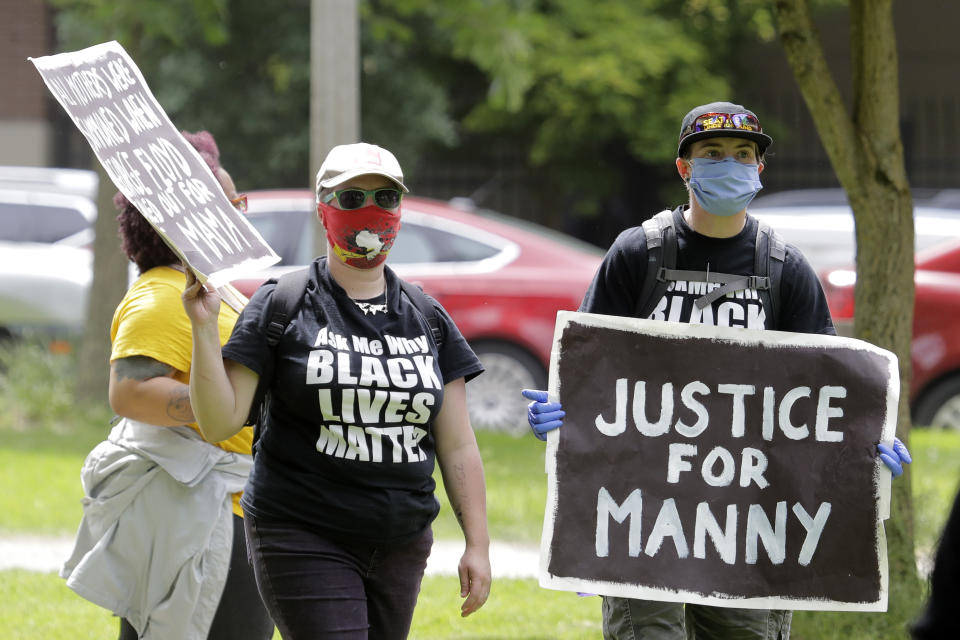 FILE - A protester holds a sign that reads "Justice for Manny" in this June 5, 2020 file photo in Tacoma, Wash., during a protest against police brutality. A jury cleared three Washington state police officers of all criminal charges Thursday, Dec. 21, 2023 in the 2020 death of Manuel Ellis, a Black man who was shocked, beaten and restrained face down on a Tacoma sidewalk as he pleaded for breath.. (AP Photo/Ted S. Warren, File)