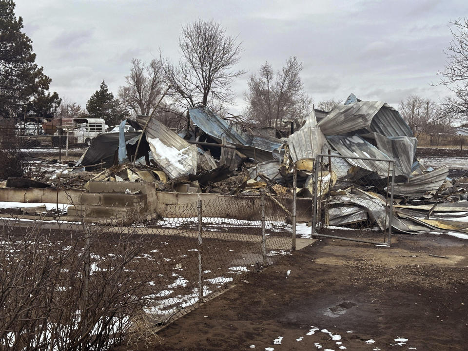 Snow covers a home that was destroyed by the Smokehouse Creek fire in Stinnett, Texas on Thursday, Feb. 29, 2024. The wildfire spreading across the Texas Panhandle became the largest in state history Thursday, as a dusting of snow covered scorched grassland, dead cattle and burned out homes and gave firefighters a brief window of relief in desperate efforts to corral the blaze.(AP Photo/Ty O'Neil)