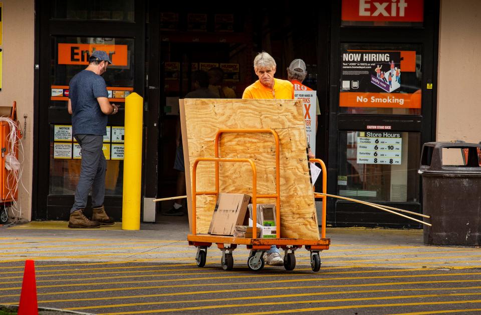 People prepare for the hurricane by buying construction materials at Home Depot in Lakeland on Tuesday.