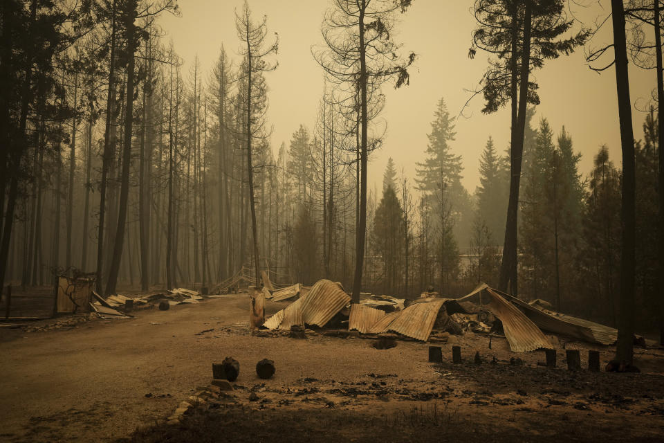 The remnants of a property that was destroyed by the Lower East Adams Lake wildfire litters the ground in Scotch Creek, British Columbia, on Sunday, Aug. 20, 2023. (Darryl Dyck/The Canadian Press via AP)