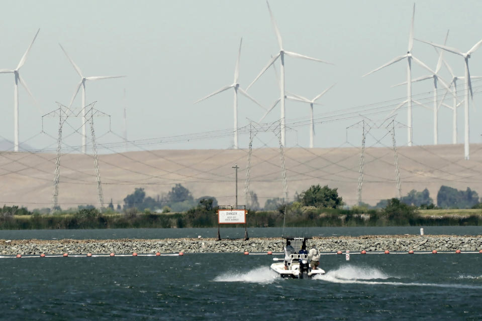 A boat approaches the temporary emergency drought barrier built by the California Department of Water Resources on West False River near Oakley Calif., on Monday, July 21, 2022. Plans to remove the barrier last fall were scrapped due to dry conditions. It protects against saltwater getting into the state’s water supply. (AP Photo/Rich Pedroncelli)