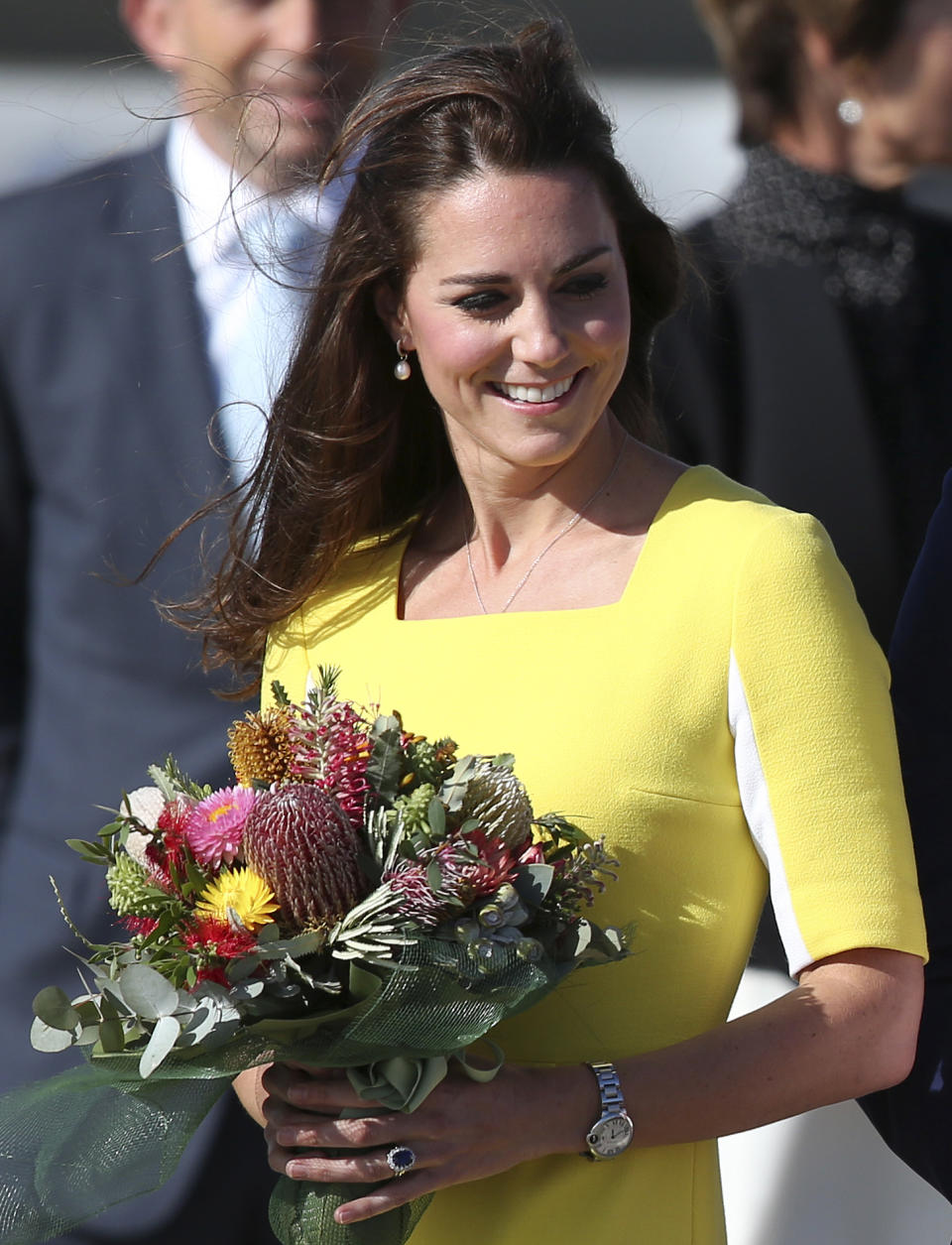 Britain's Kate, Duchess of Cambridge, with a bouquet of flowers arrives in Sydney Wednesday, April 16, 2014. Britain's Prince William and Kate are on a three-week tour of Australia and New Zealand, the first official trip overseas with their son, Prince George. (AP Photo/Rob Griffith)