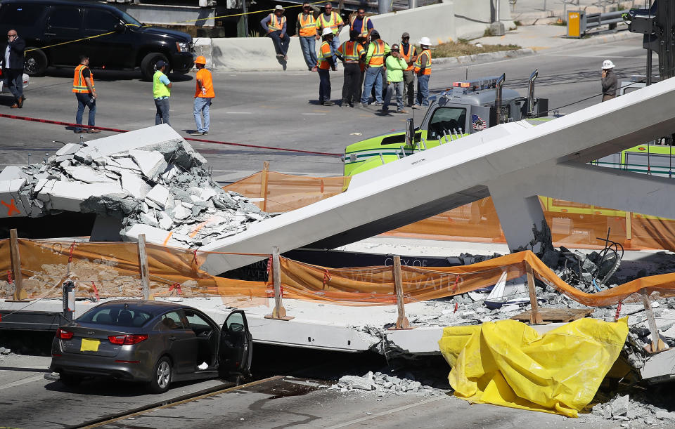 Miami-Dade Fire Rescue personnel and other rescue units work at the scene.