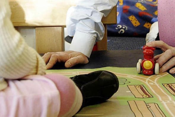 File photo dated 11/11/04 of an adult playing with a child at a nursery. A childcare tax break for working parents will be more generous than expected and expanded to older children more quickly, the Government announced ahead of the Budget. PRESS ASSOCIATION Photo. Issue date: Tuesday March 18, 2014. The new scheme - due to come into force from the autumn of 2015 - will be worth up to ?2,000 per child, compared with the ?1,200 originally proposed. See PA story POLITICS Budget. Photo credit should read: Edmond Terakopian/PA Wire