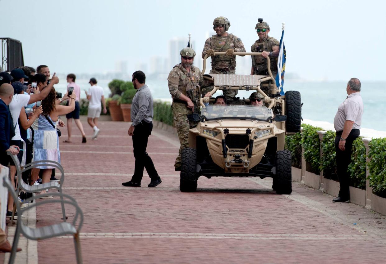 Navy SEALs demonstrate the apprehending of a suspect.