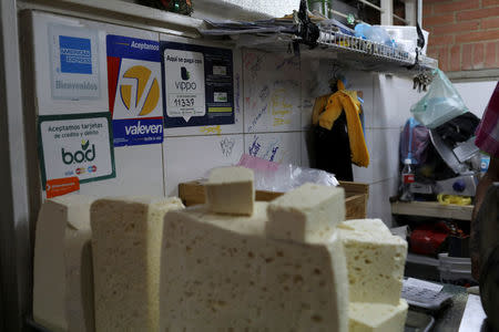 Information for Vippo app and other methods of payment is seen at a cheese and dairy products stall at Chacao Municipal Market in Caracas, Venezuela January 19, 2018. REUTERS/Marco Bello