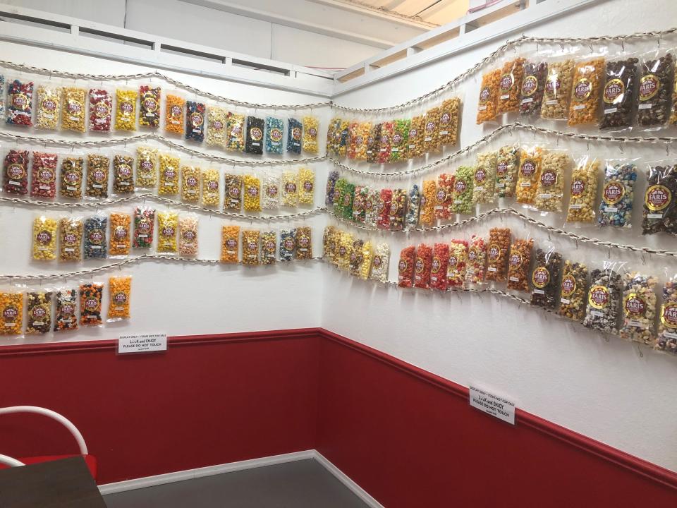 FILE - Upon walking into the Faris Gourmet Popcorn retail shop, customers will see a wall of popcorn options in various flavors and colors.