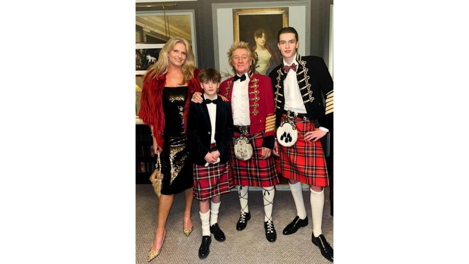 Alastair and Aiden Stewart wearing kilts, next to mum Penny Lancaster and dad Rod Stewart