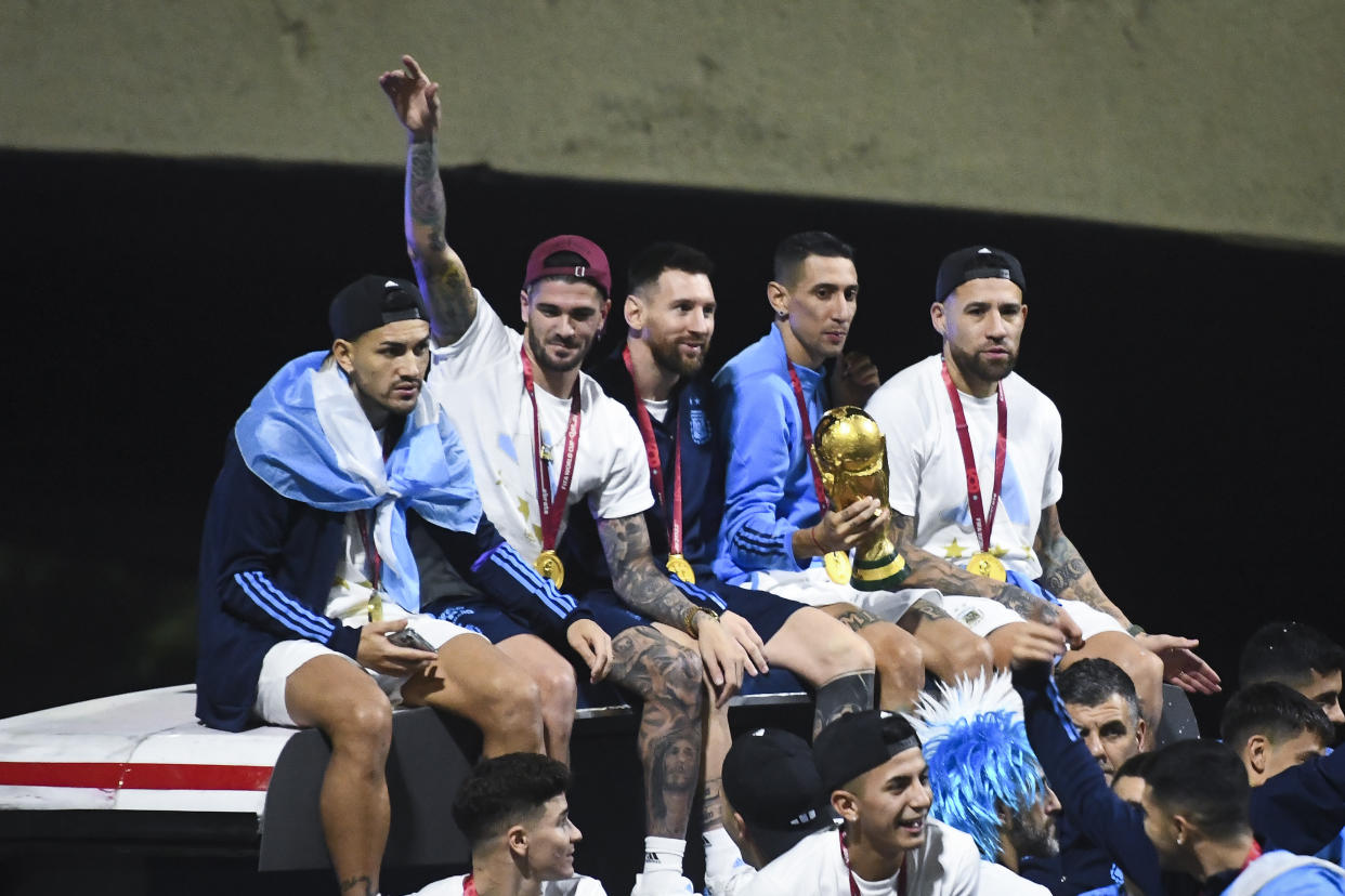 Leandro Paredes, Rodrigo De Paul, Lionel Messi, Angel Di Maria and Nicolas Otamendi celebrate on the bus during the arrival of the Argentina men's national football team after winning the FIFA World Cup on Tuesday