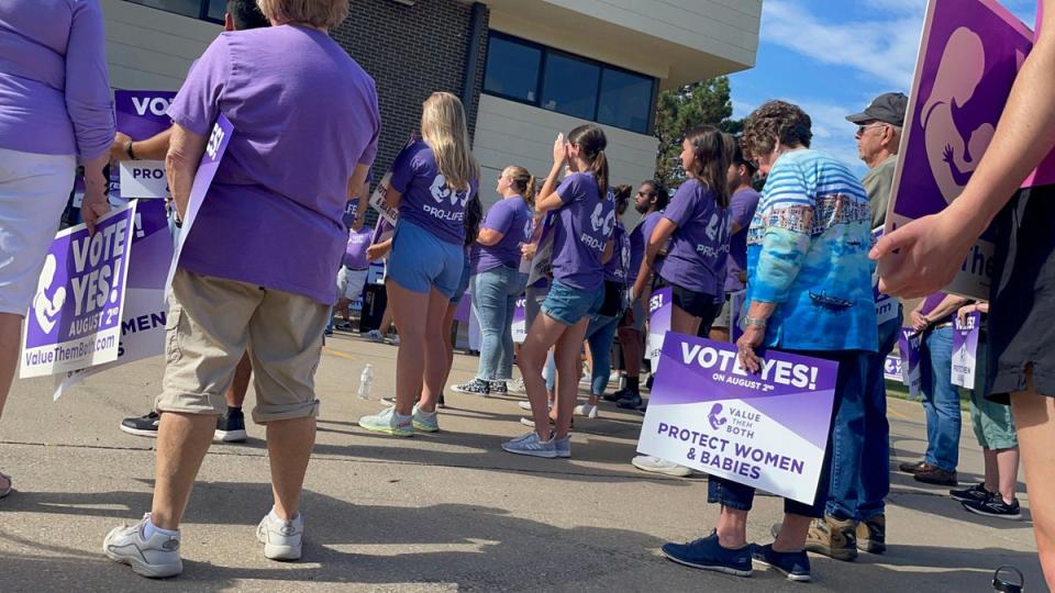 Anti-abortion supporters of a state constitutional amendment to remove language enshrining abortion rights in Kansas hold a rally on 30 July. (AFP via Getty Images)